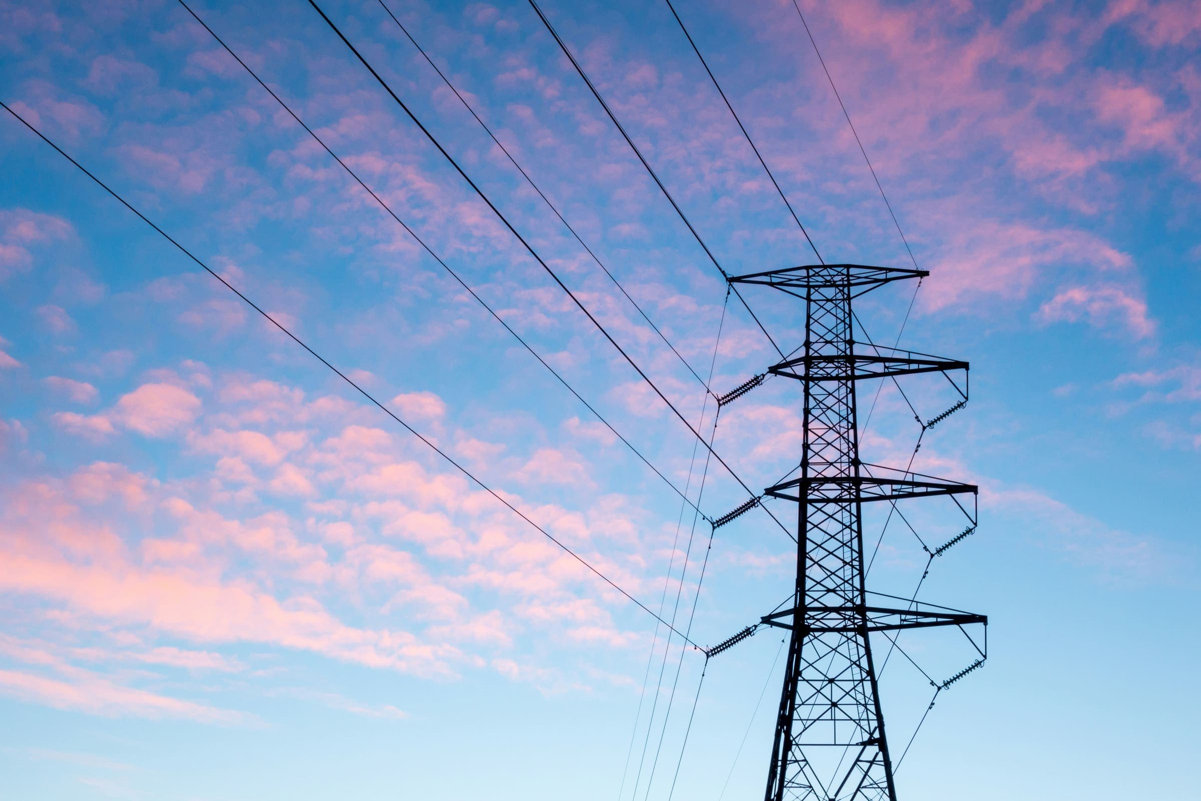 High-voltage transmission towers at sunset